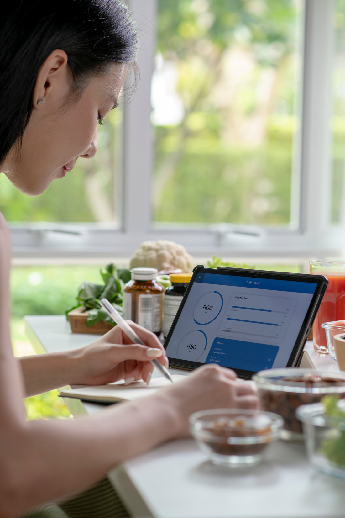 Nutritionist working and checking data from a tablet