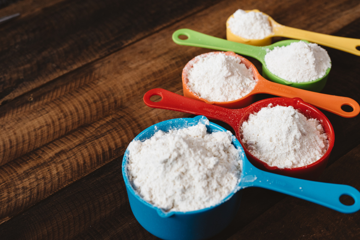 Colorful Measuring Cup On Wooden Table
